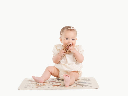 Image of a baby in a padded mat