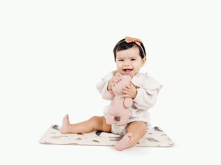 image of a baby sitting in a mat