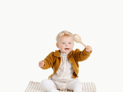 Image of a baby in a padded mat